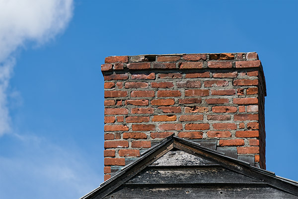 Chimney in Need of Repair on Roof Housetop