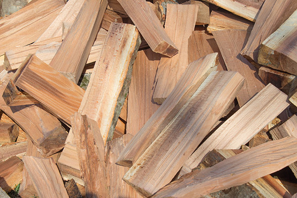 Firewood background - chopped firewood on a stack.