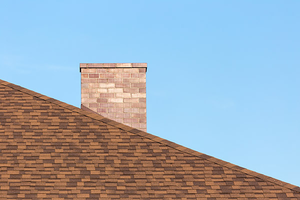 Chimney on angled rooftop.